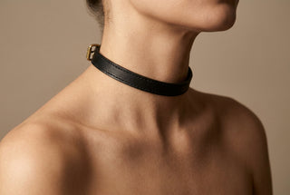 Slim black leather choker on the neck