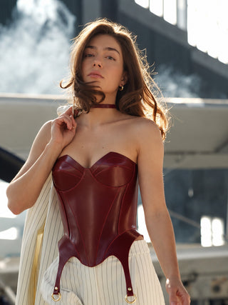 Red leather corset HELLA styled with a white pinstripe suit